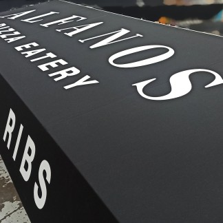 Process — fabric cut; stencil masking in place, applying white paint lettering (“ALFANOS / PIZZA EATERY”), prev. employer