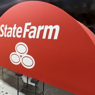 3/4 view — red acrylic canopy; sign State Farm wordmark painted white through a stencil (prev. employer, lettering applied by Sunwell)
